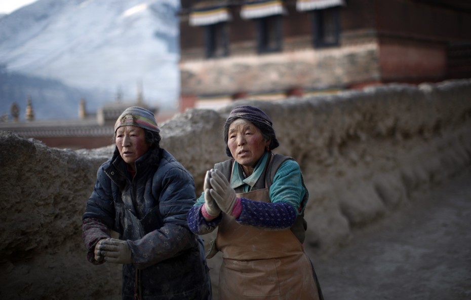 Ethnic Tibetan women pray around the Labrang Monastery ahead of the Tibetan New Year which starts on Wednesday in Xiahe county