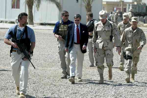 Blackwater personnel escorting Paul Bremer, an American civil administrator, upon his arrival in Ramadi, Iraq, in March 2004. [Reuters]