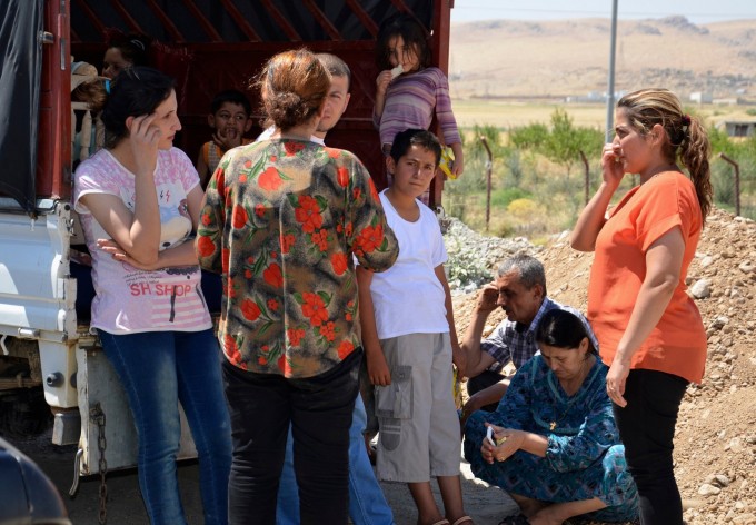 Iraqis who fled violence in Nineveh Province arrived at Sulaimaniya, in the northern Kurdish territories on Friday. [Reuters]