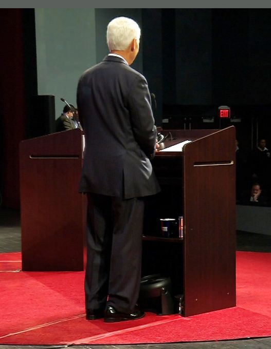 This video frame grab made available by CBS 4, shows a fan at the bottom of the lectern near Democratic gubernatorial candidate Charlie Crist in Davie, Fla., Wednesday Oct. 15, 2014. The fan caused a delay in the gubernatorial debate between Crist and Governor Rick Scott, after the Scott campaign considered the fan a violation of the rules prohibiting the use of electronic devices.
