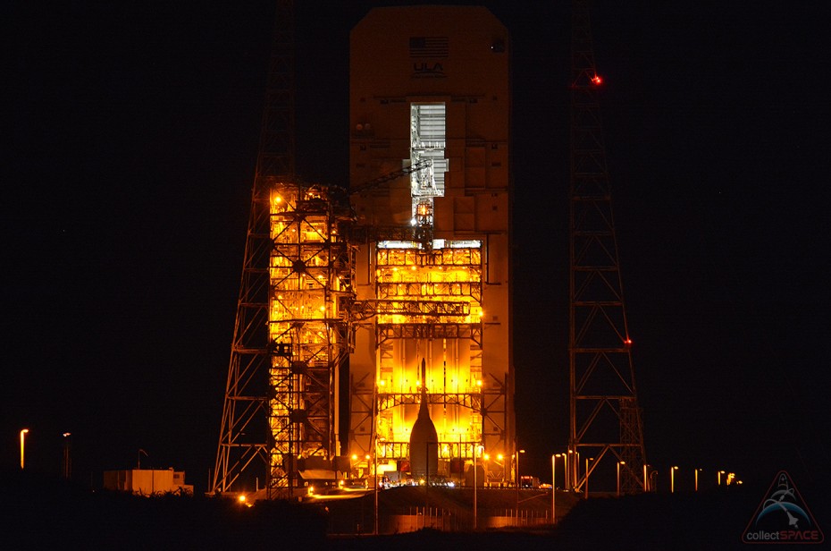NASA's first space-bound Orion capsule is seen in silhouette, set against the pad lights at Cape Canaveral Air Force Station Space Launch Complex 37B on Wednesday, Nov. 12. (collectSPACE)
