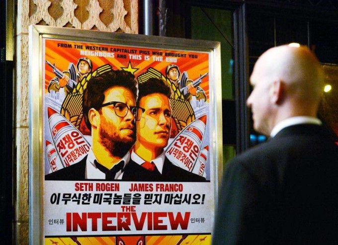 A security guard stands at the entrance of United Artists theater during the premiere of the film ''The Interview'' in Los Angeles, California December 11, 2014. [REUTERS]