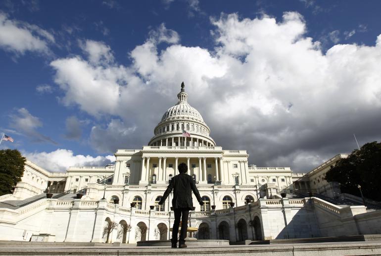 The U.S. Capitol, with a gazing tourist. Image: Reuters.