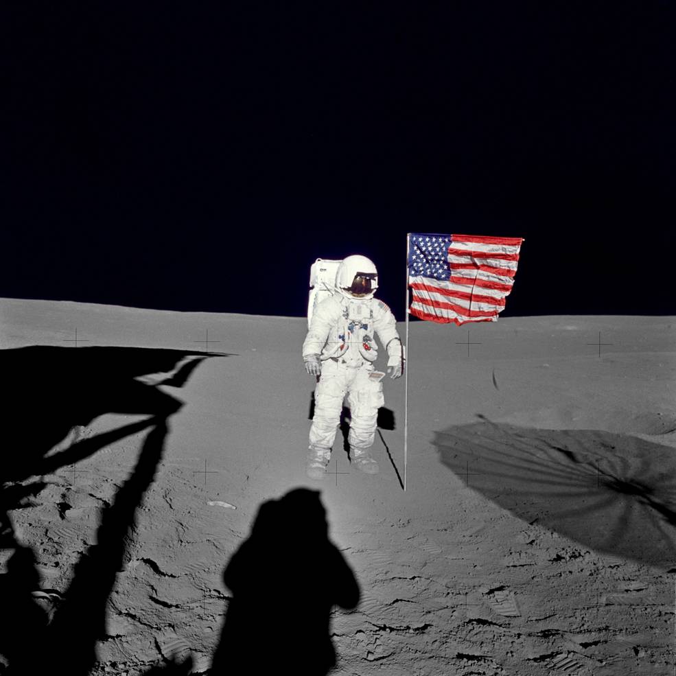 Astronaut Edgar D. Mitchell, Apollo 14 lunar module pilot stands by the deployed U.S. flag on the lunar surface during the early moments of the mission's first spacewalk. Photo: NASA