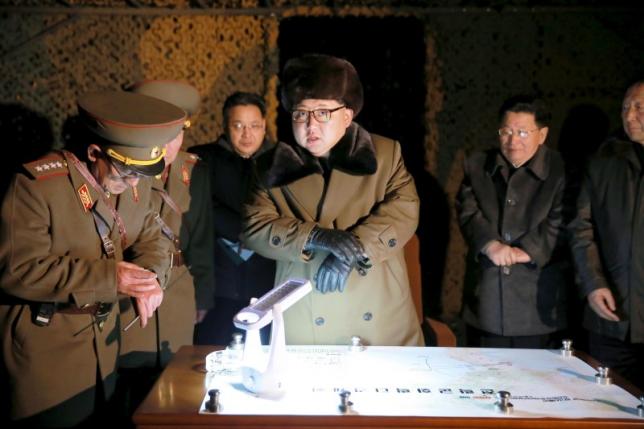 North Korean leader Kim Jong Un talks with officials at the ballistic rocket launch drill of the Strategic Force of the Korean People's Army (KPA) at an unknown location, in this undated photo released by North Korea's Central News Agency (KCNA) on March 11, 2016.