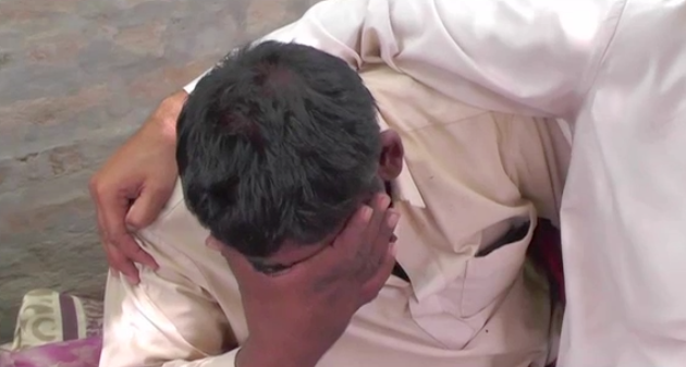 Umar Hayat grieves after the mass poisoning event that killed 31 members of his extended family.