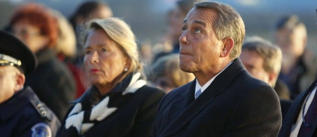 Boehner, sitting with his wife Debbie (REUTERS/Jonathan Ernst)