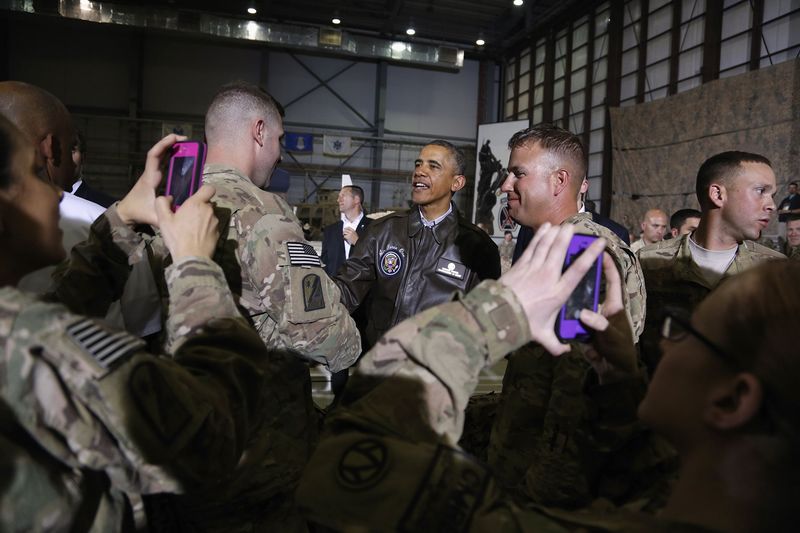 Soldiers take photos as U.S. President Barack Obama (C) shakes hands with troops after delivering remarks at Bagram Air Base in Kabul, May 25, 2014. (Reuters/Jonathan Ernst)
