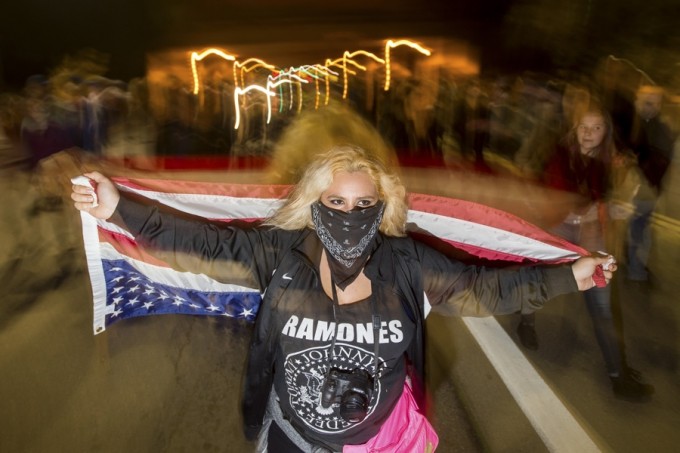 A anti-police protester who declined to give her name marches through Oakland, California December 10, 2014.  REUTERS/Noah Berger 