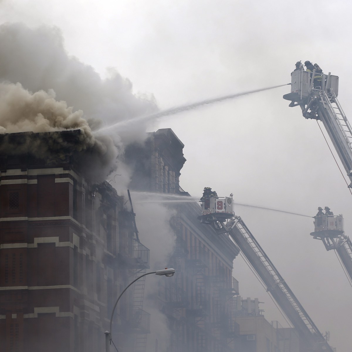 Firefighters battle fire at the site of a residential apartment