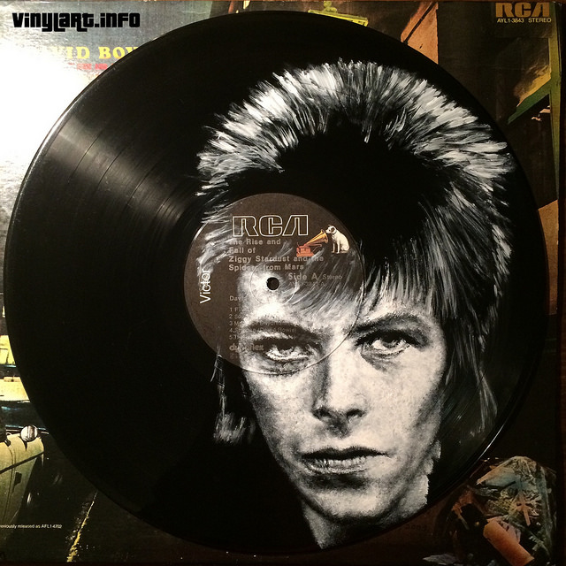 Hand-painted portraits of famous musicians, on vinyl records