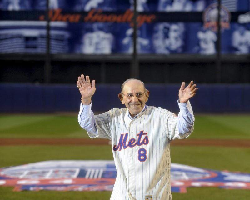 Former New York Mets manager Yogi Berra waves as he passes home plate during ceremonies after the final regular season MLB National baseball game at Shea Stadium in New York in  2008. REUTERS