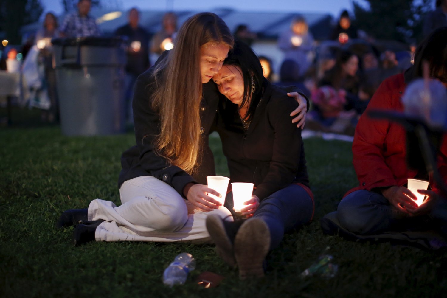 Heidi Wickersham (L), 31, comforts her sister Gwendoline Wickersham, 28, after the Umpqua massacre. REUTERS