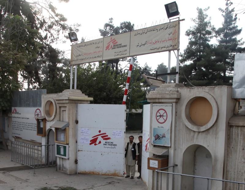 Afghan guards stand at the gate of MSF hospital after an air strike in the city of Kunduz. REUTERS