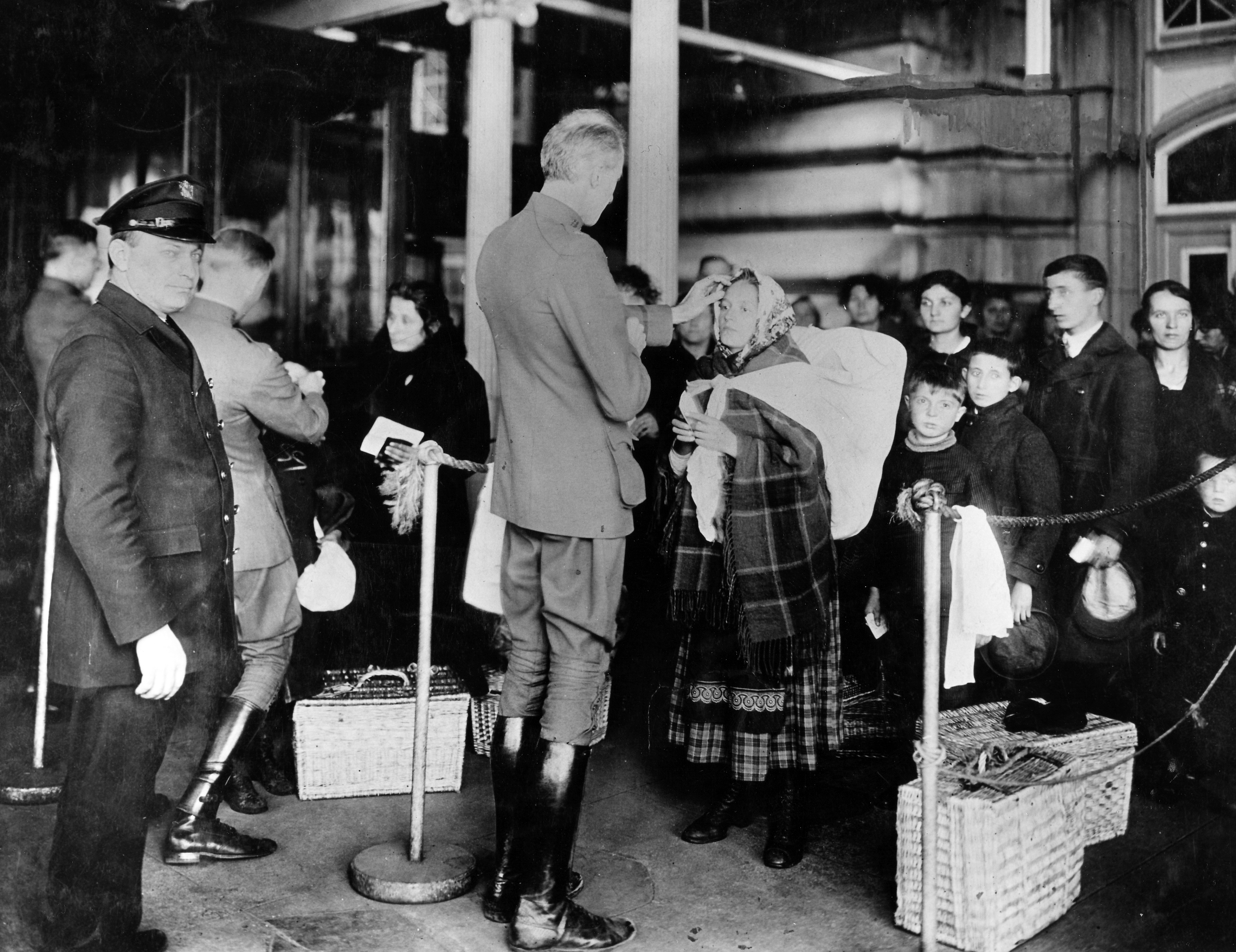 Public Health Service officers examining immigrants arriving to Ellis Island