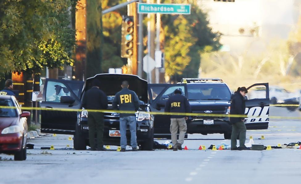 FBI and police are seen around a vehicle in which two shooters were killed following a mass shooting in San Bernardino.  REUTERS/Mike Blake