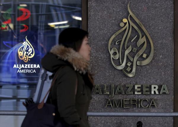 A woman passes by the Al Jazeera America broadcast center in NYC Jan. 13, 2016.  REUTERS