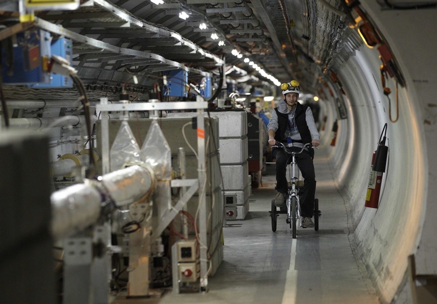 A technician cycles in the Large Hadron Collider (LHC) at CERN. [Reuters]