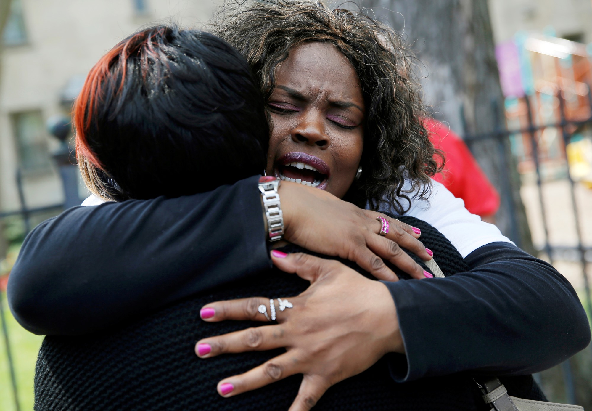 Nortasha Stingiey (R) hugs Lutrice Boyd at a "Purpose over Pain" gathering. The group of mothers who lost children to gun violence are calling for a stop to shootings in Chicago. May 6, 2016. REUTERS/Jim Young