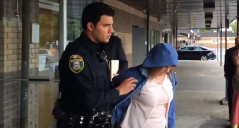Kelly Aldinger escorted by police officer after arraignment . Image: WFMZ