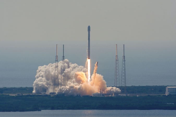 As seen from VAB roof at NASA Kennedy, Falcon 9 rocket lifts off at 10:29 a.m. EDT with Eutelsat 117 West B and ABS 2A comms satellites. Photo: SpaceFlightNow.