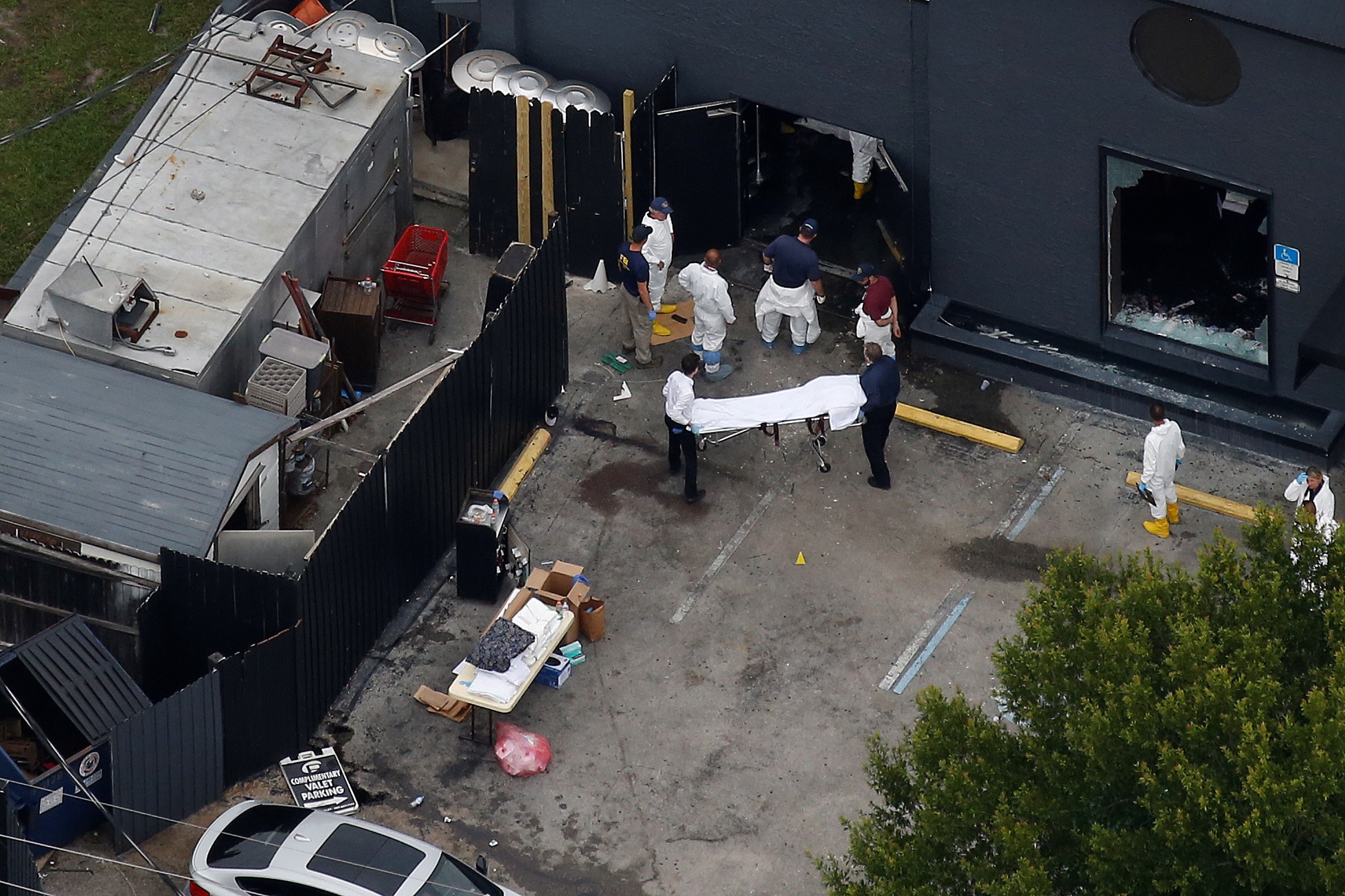 Investigators work the scene following a mass shooting at the Pulse gay nightclub in Orlando Florida,  June 12, 2016. REUTERS/Carlo Allegri