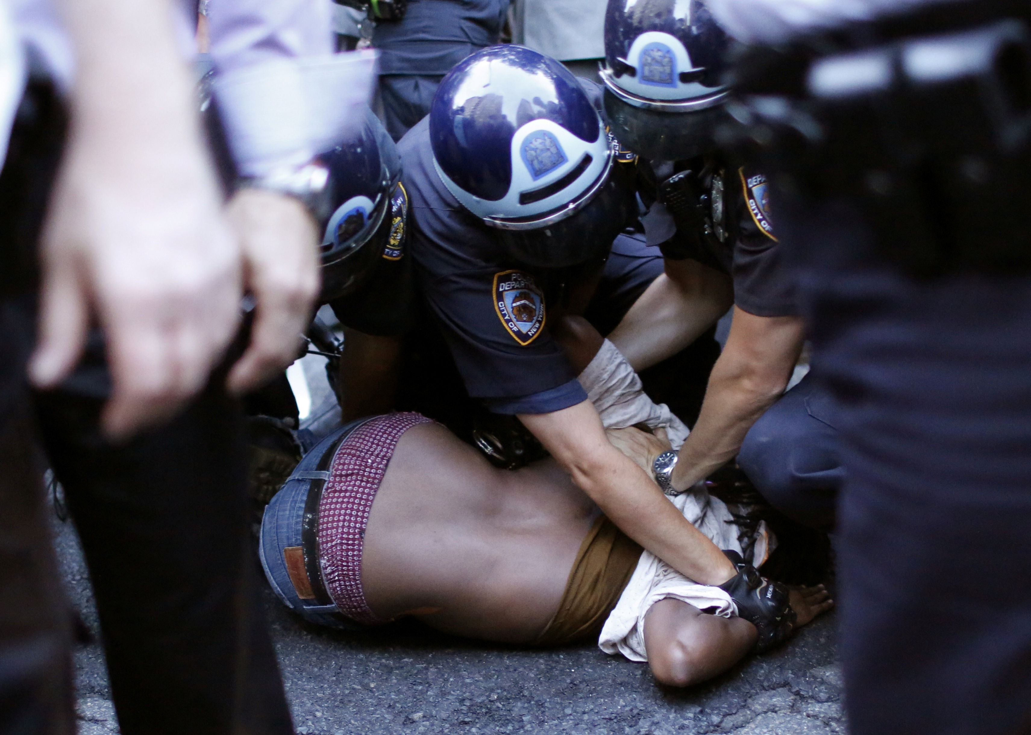 A protestor is detained by NYPD officer as people take part in a protest for the killing of Alton Sterling and Philando Castile during a march along Manhattan's streets in New York July 7, 2016. REUTERS/Eduardo Muoz