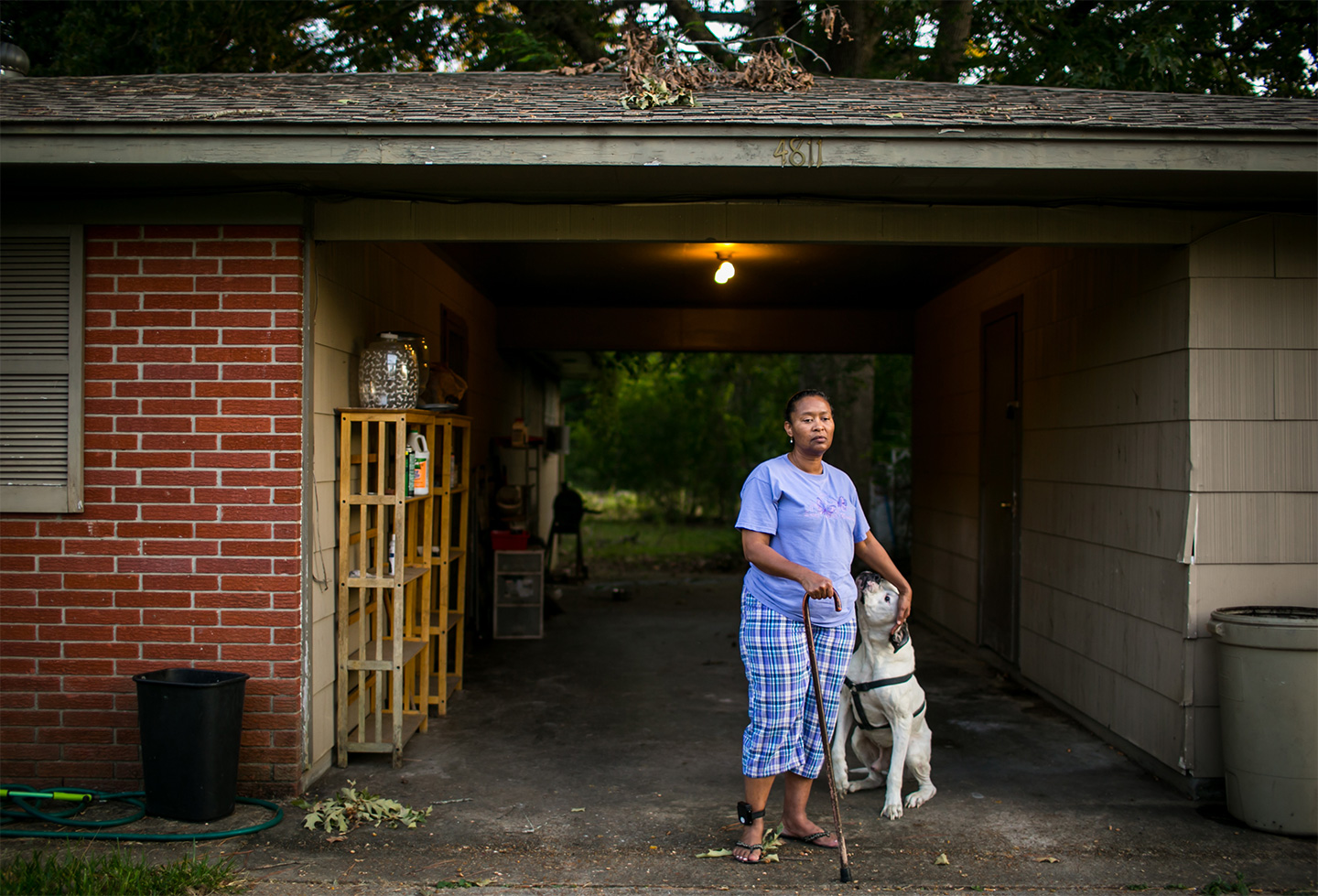 Tennie White outside of her home in Jackson, Mississippi. Currently on house arrest after 32 months in prison, Tennie cannot walk farther than her mailbox. Ms. White helped to uncover contaminated areas from the Kerr McGee site and was later charged with tampering with evidence during court trials against the company for environmental pollution. During her prison sentencing, the judge assured Tennie she would receive medical attention for her cataracts, for which she was already planning to undergo surgery. Being refused the appropriate medical care, she is now legally blind after being released to her home.