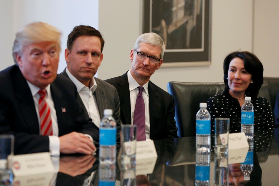 U.S. President-elect Donald Trump speaks as (2nd L to R) PayPal co-founder and Facebook board member Peter Thiel, Apple Inc CEO Tim Cook and Oracle CEO Safra Catz look on during a meeting with technology leaders at Trump Tower in New York U.S., December 14, 2016. REUTERS/Shannon Stapleton - RTX2V24O